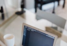 Control whether PDFs open in Office Online or the default PDF reader. person holding a document while using laptop